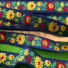 Kép 1/3 - Hímzett szalag – Matyó mintával, kék alapon sárga-piros virággal, 4cm