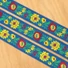 Kép 1/2 - Hímzett szalag – Matyó mintával, kék alapon sárga-piros virággal, 3,3cm